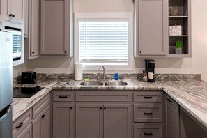 A kitchen with a sink, countertop, and cabinets. - Perfect Cabin Retreat for Four in Livingston, Texas (Livingston)