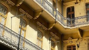 A multi-story building with ornate balconies and classic architectural details.