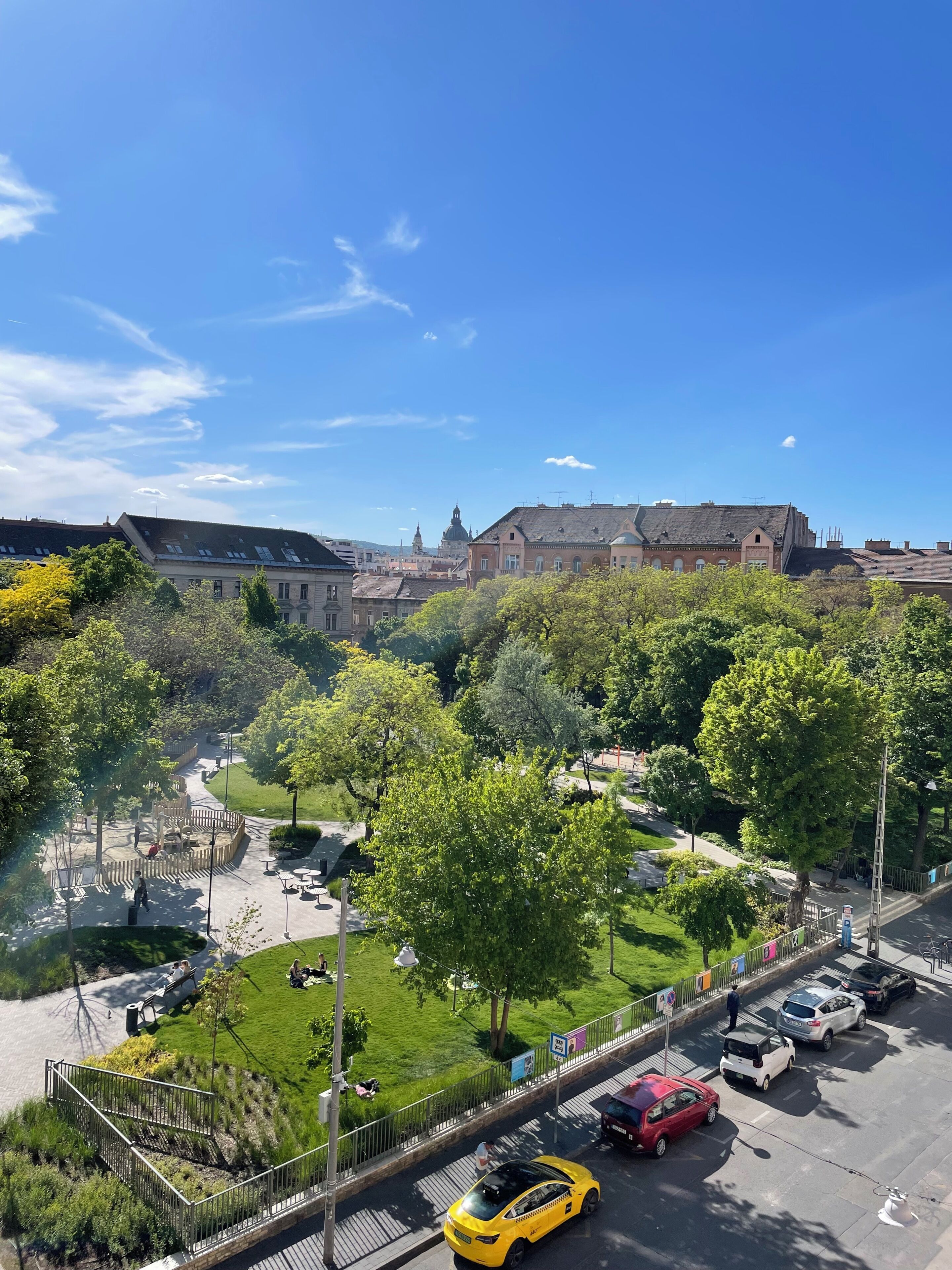 A park with pathways, benches, and a playground.