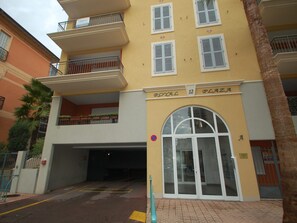 A multi-story building with balconies and a ground-level entrance. - AC studio in Menton city center (Menton)