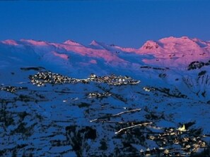 A snow-covered mountain range with a town at the base. - Ideal apartment near slopes - 6 guests (Orcières Merlette)