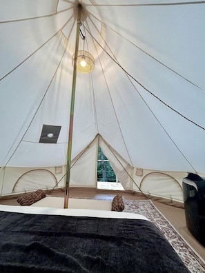 A tent with a central pole, a hanging light fixture, and a window. - Mt. Magazine Tent (Gentry)