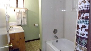 A bathroom with a sink, toilet, and shower. - Spacious Cabin with Large Porch Ideal for Groups in Arizona (Flagstaff)