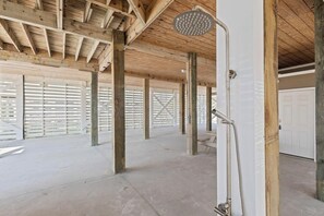 An open-plan room with a shower, wooden beams, and a white door. - New Listing!  In Morgantown w/ Pools, Tennis/Pickleball (Gulf Shores)