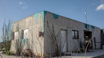 A building with a concrete exterior, a door, and windows.