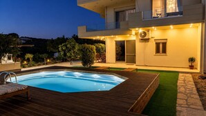 A modern two-story house with a swimming pool, outdoor furniture, and a well-maintained garden. - Olive & Raki Luxury Pool Villa, Crete Garden Oasis (Agioi Theodoroi)