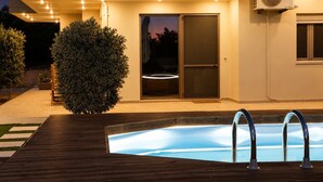 A modern house with a swimming pool, a large bush, and an air conditioning unit. - Olive & Raki Luxury Pool Villa, Crete Garden Oasis (Agioi Theodoroi)