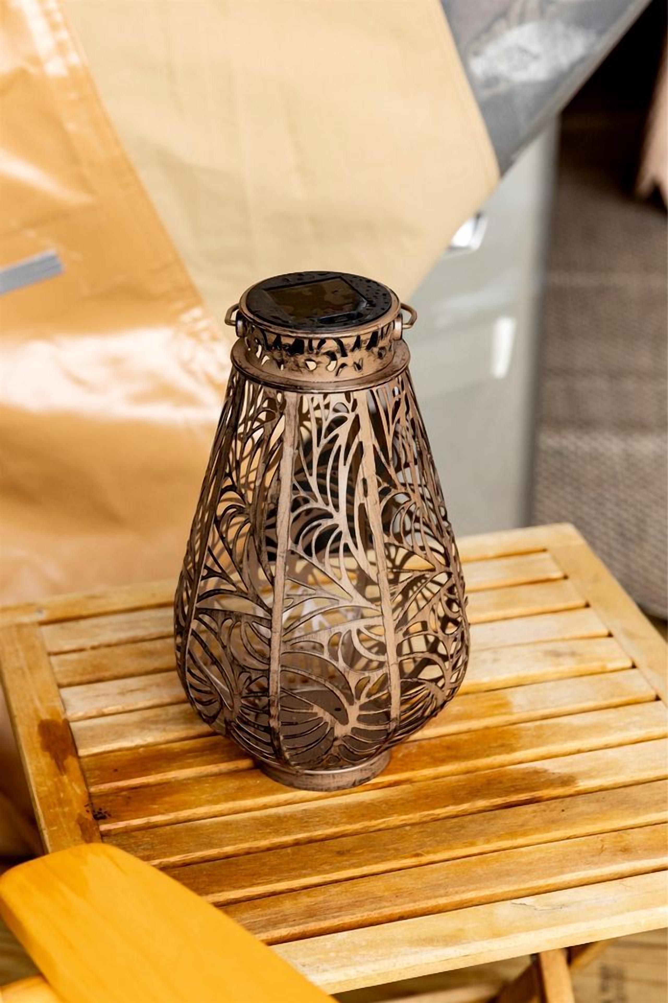 A decorative metal lantern on a wooden table.