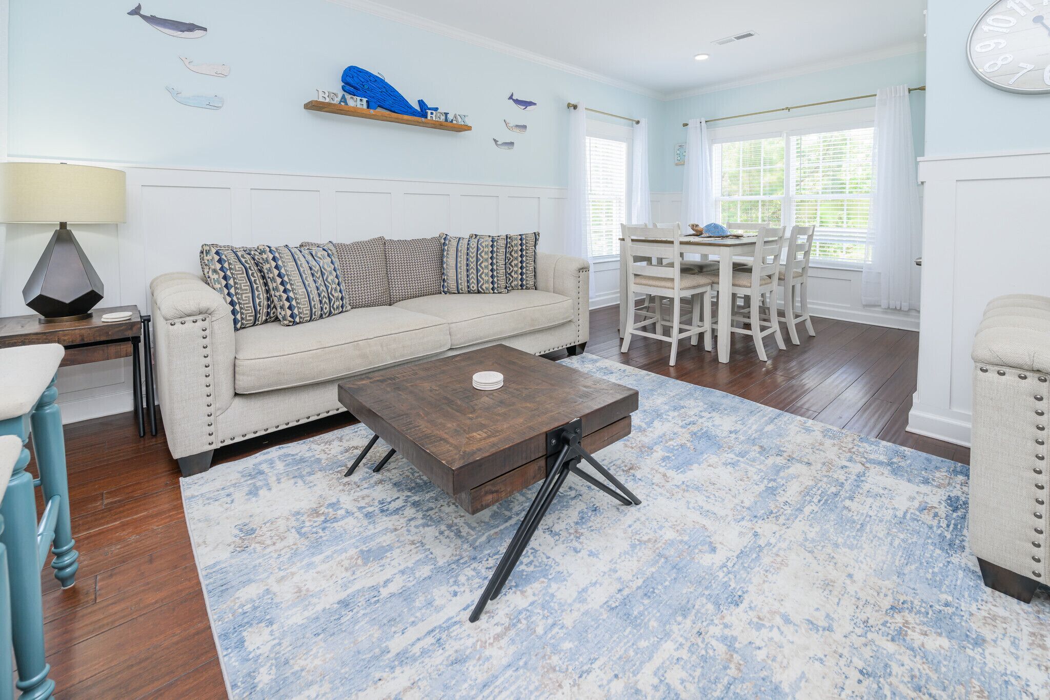 A living room with a sofa, coffee table, and dining area.