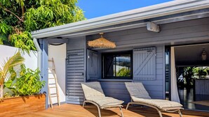 A poolside area with two lounge chairs, a wooden deck, and a small pool. - La Caze Na Nou - elegant villa with a private pool (Saint Gilles les Bains)