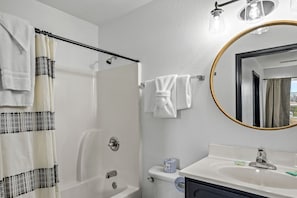 A bathroom with a shower, a sink, a toilet, and a mirror. - Comfortable Retreat with Hot-Tub in Sevierville, Tennessee (Sevierville)
