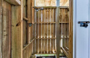 A wooden interior with a metal rack and a showerhead. - Joan and Eddie's Beach Retreat: Pet Friendly | Walking Distance to Beach (Carolina Beach)