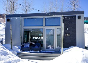 A modern building with a glass entrance, a sign indicating it's a ski lodge, and a number '5' on the side. - Contemporary Mesa Accommodation Ideal for Glamping in Colorado (Mesa)