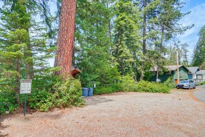 A gravel parking area with a sign indicating reserved parking for Margie. - Private Dock, Deck & Yard: Luxe Sacheen Lake Home (Newport)
