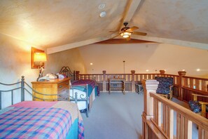 A bedroom with two beds, a desk, a chair, a ceiling fan, and a staircase. - Colorado Riverfront Escape! Fish, Hike & Relax (Pine)