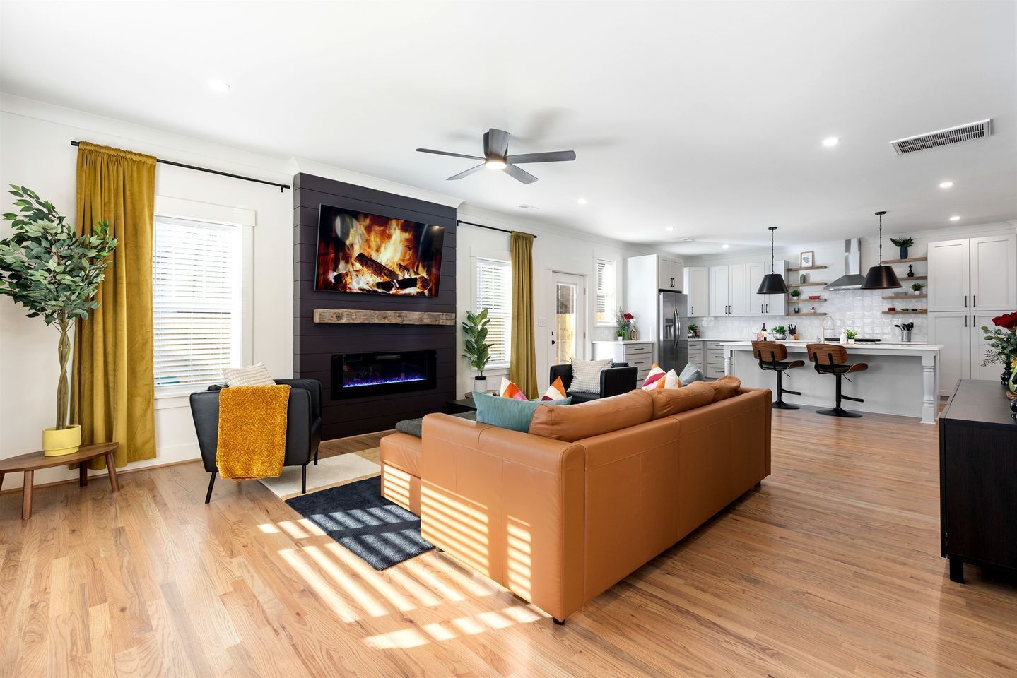 A modern living room with a fireplace, a sofa, and a television.
