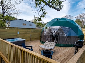 A deck with a hot tub, a covered tent, and a grill. - Geodesic Dome Retreat with Hot Tub & Fire Pit in Bluefield, West Virginia (Blueflield)