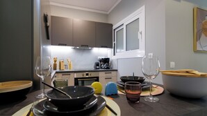 A modern kitchen with dark cabinets, a microwave, and a coffee maker. - 
Silk Luxury 1 bedroom Hideout in Vari (Vari)