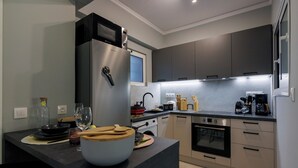 A modern kitchen with a built-in oven, microwave, and stainless steel refrigerator. - 
Silk Luxury 1 bedroom Hideout in Vari (Vari)