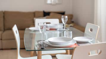 A dining table set with plates, glasses, and cutlery.
