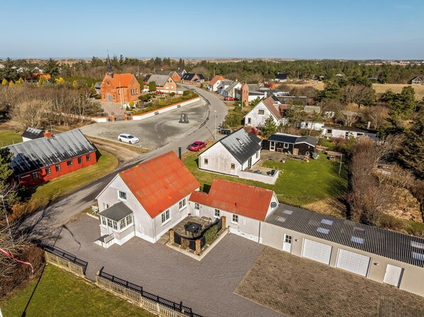 A residential area with houses, a road, and a church.