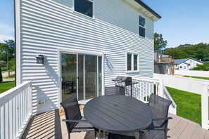 A house with a deck, a grill, and a sliding glass door. - Cedar Lake 4br Home For 8 W/ Lake Views 4 Bedroom Home (Cedar Lake)