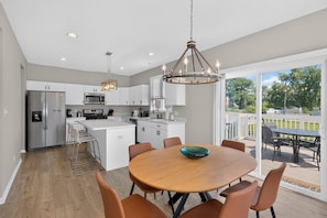A modern kitchen with white cabinets, stainless steel appliances, and a central island. - Cedar Lake 4br Home For 8 W/ Lake Views 4 Bedroom Home (Cedar Lake)