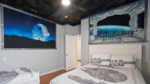 A bedroom with a bed featuring Star Wars-themed bedding, a mural of a space station, and a view of Earth from a spacecraft window. - Fp8204 4 Bedroom Home (Kissimmee)