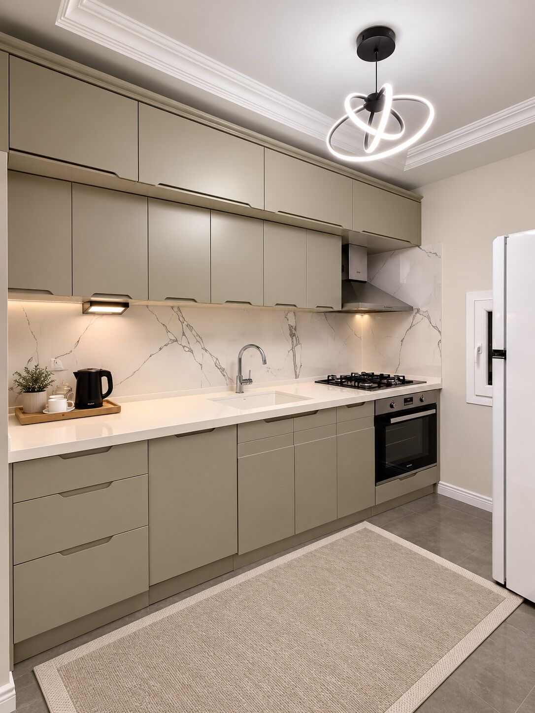 A modern kitchen with a marble backsplash, built-in cabinets, a gas stove, and a white refrigerator.