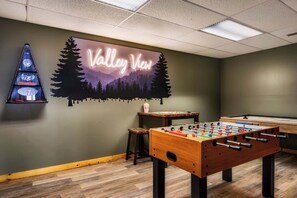 A room with a foosball table, a pool table, and a wall with a 'Valley View' sign. - Two cabins - Sleeps 24 - Views - Games - Outdoors (Sevierville)