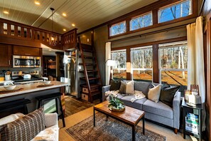 A cozy interior with a kitchen, dining area, and living room, featuring wooden elements and large windows. - Peaceful Pine Tiny House Retreat with Private Hot Tub & Mountain Views Near South Cumberland State Park, Monteagle, TN (Monteagle)