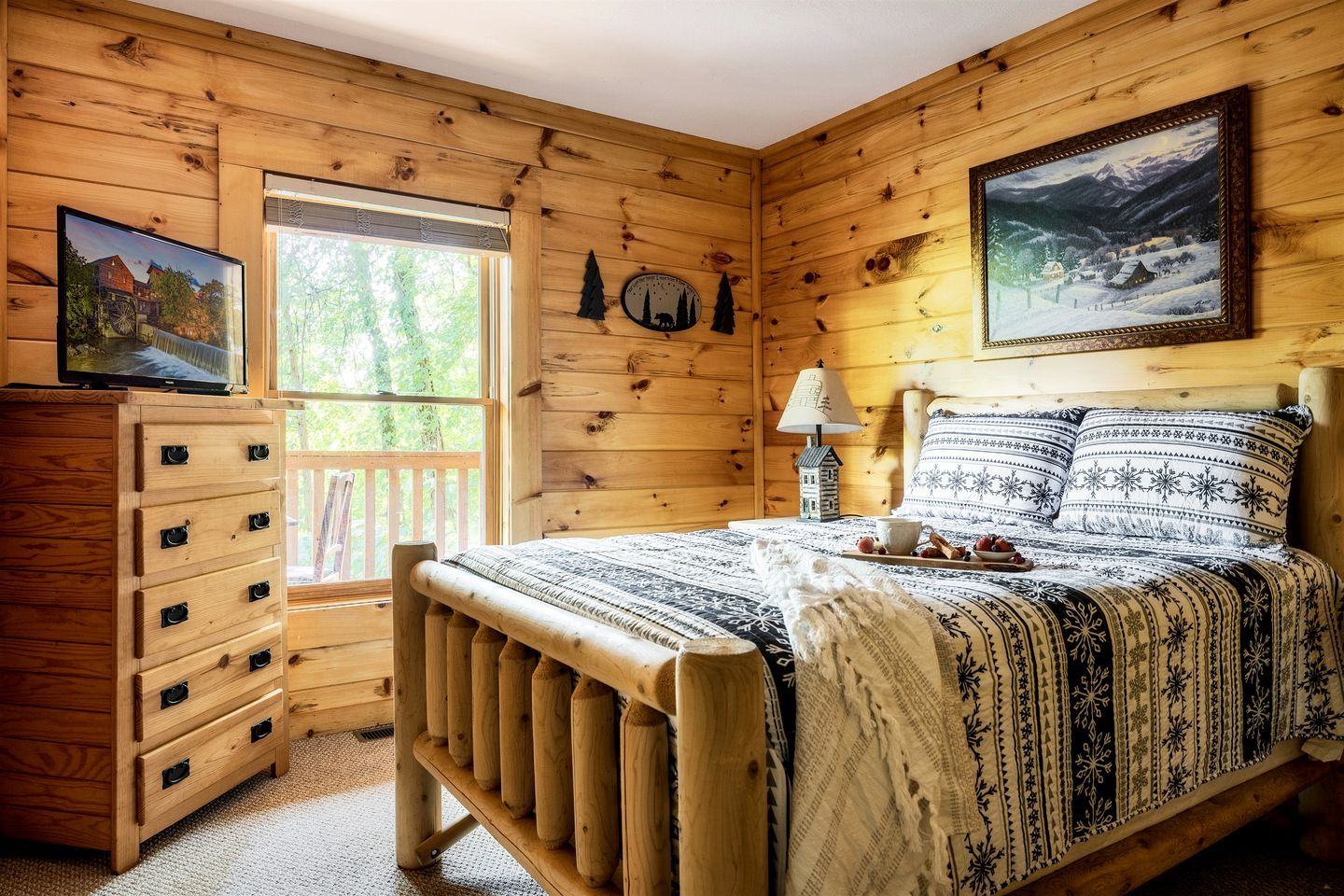 A wooden cabin bedroom with a bed, dresser, and a painting on the wall.