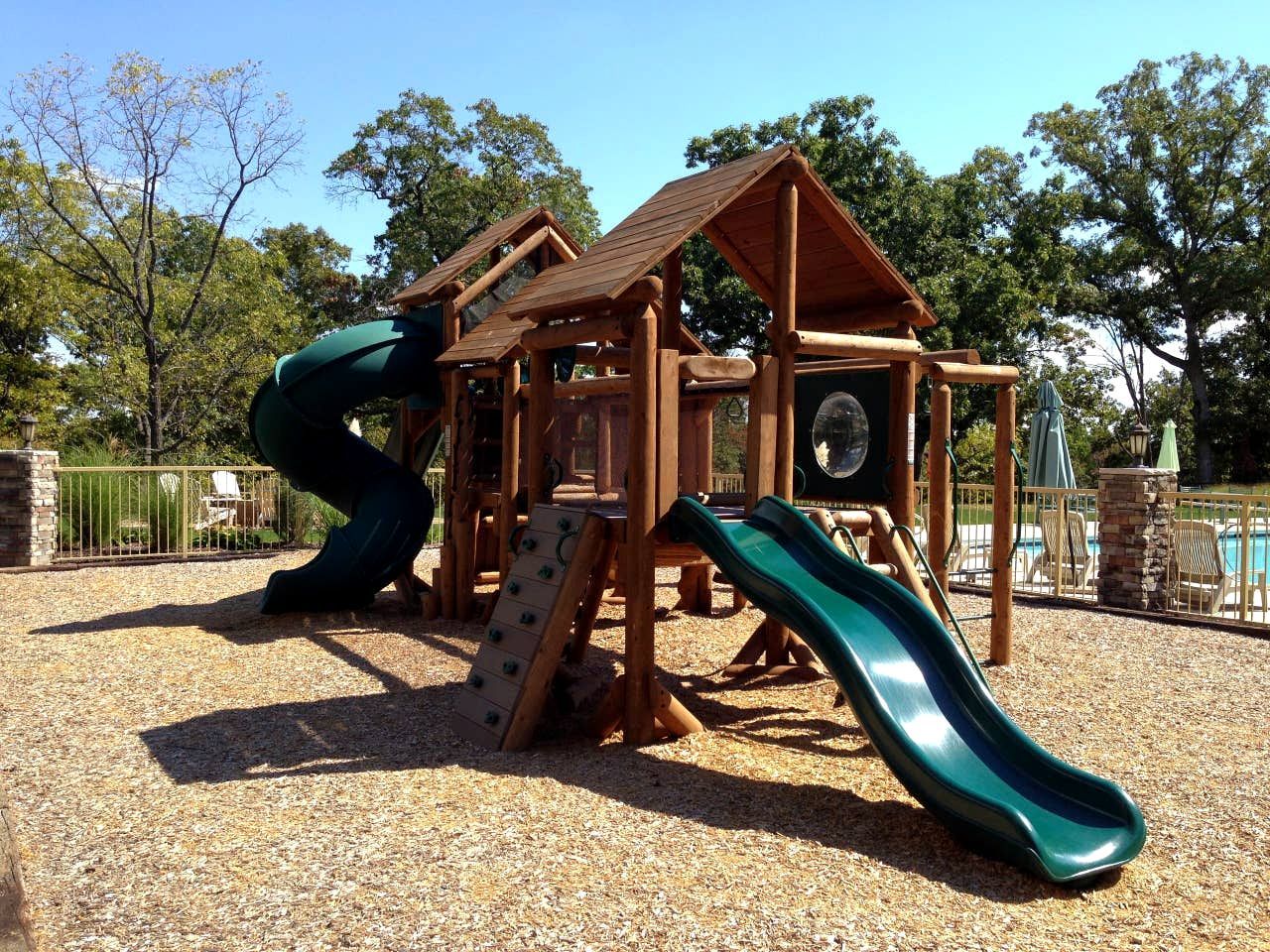 A playground with a slide and climbing structures.