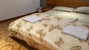 A bedroom with a bed, a framed picture on the wall, and a modern light fixture above the bed. - Bnb Fantasia (Bologna)