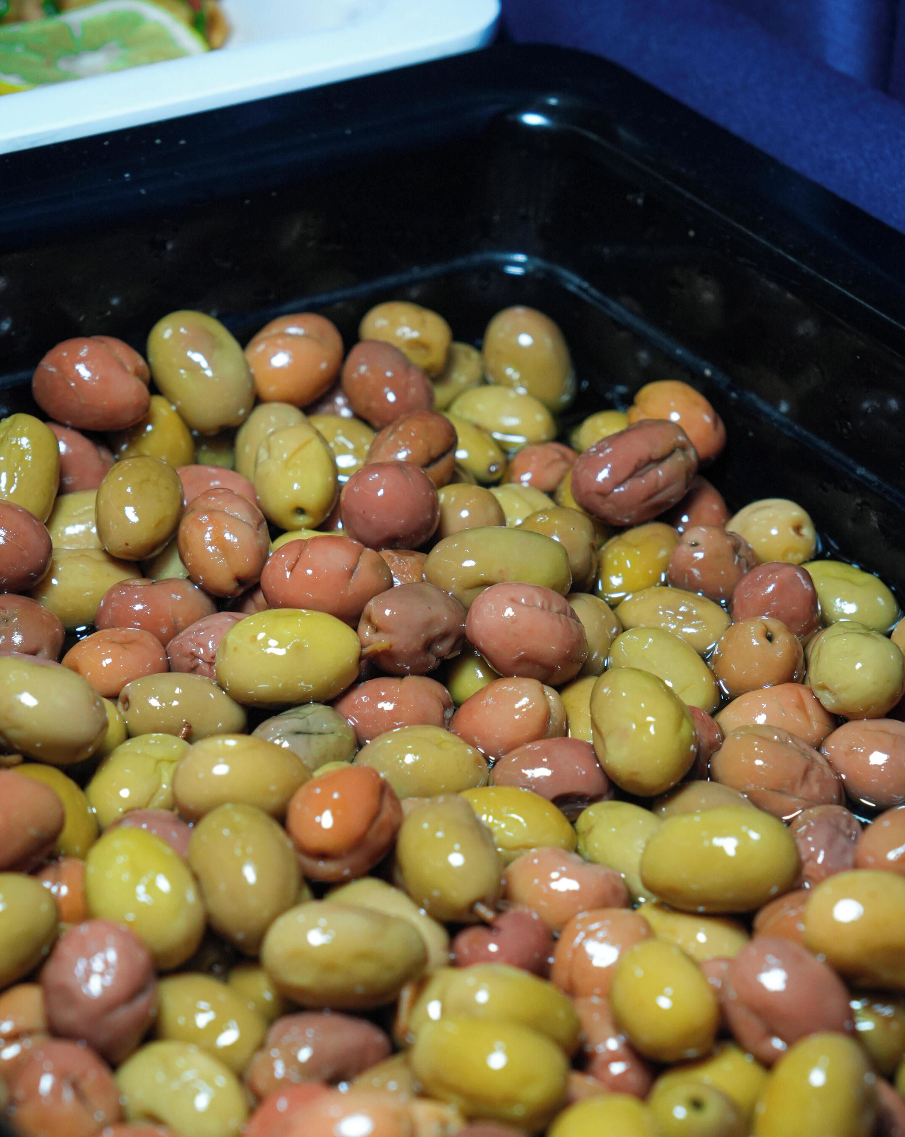 A close-up of olives in a container.