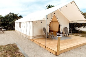 A tented accommodation with a wooden deck, two chairs, and a welcome sign. - Cozy Double Safari Tent with Fire Pit in Hobe Sound, Florida (Hobe Sound)