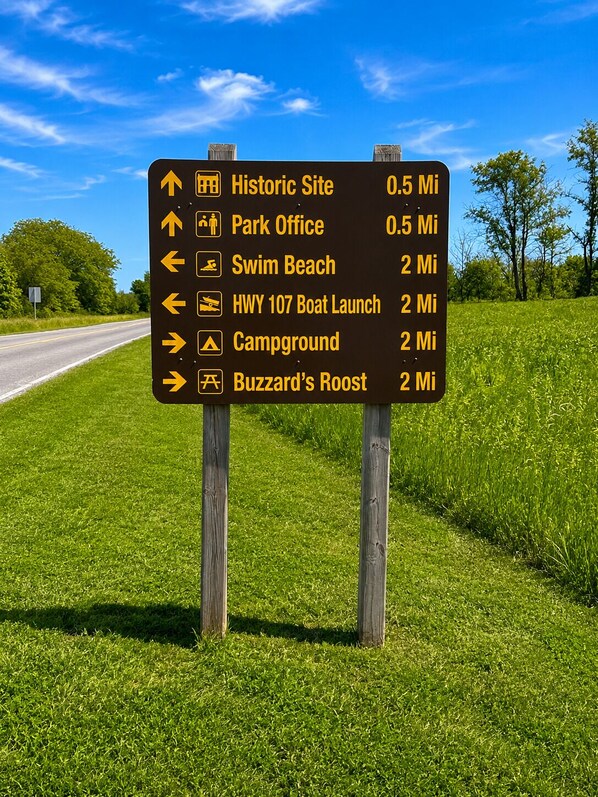 A directional sign with various destinations and distances.
