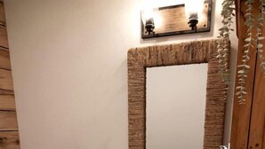 A bathroom with a toilet, sink, and mirror.