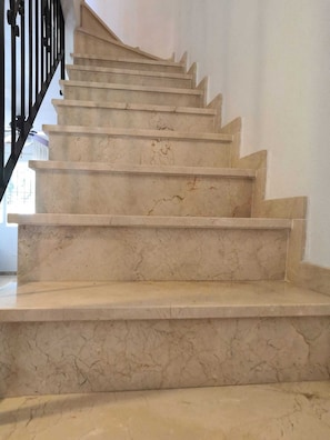 A marble staircase with a black handrail, leading to an upper floor. -  Air-conned beach holiday home close to  blue-flag beaches, bars and restaurants (Torre de la Horadada)