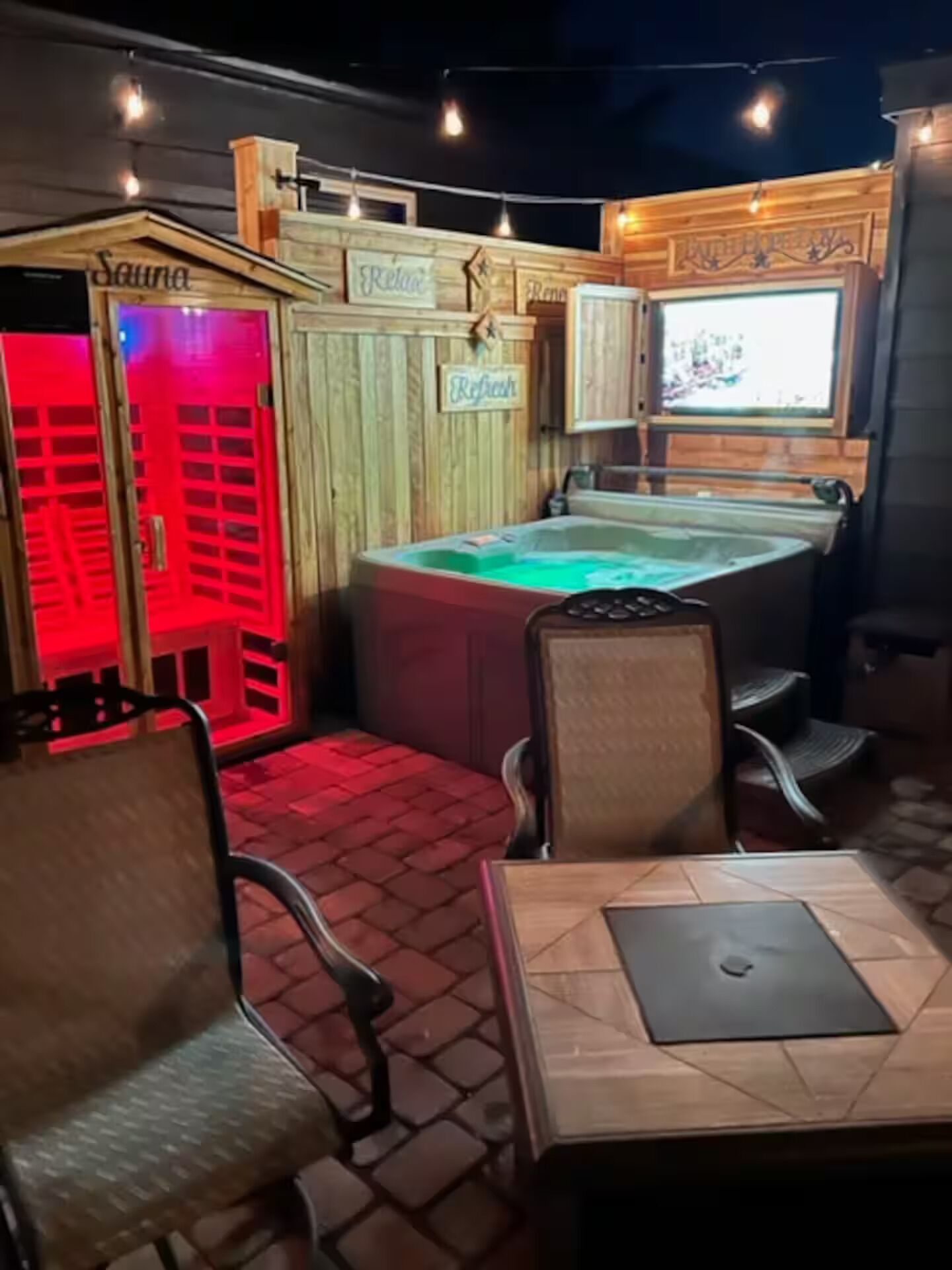 A spa area with a hot tub, wooden walls, and a sign that reads 'Relax.'