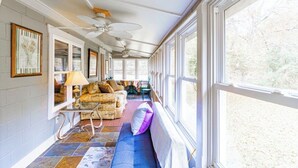 A sunlit room with a sofa, a small table, and a ceiling fan. - Farmhouse Retreat on 75 Acres with Fiber Wi-Fi, Near DeSoto (Mentone)