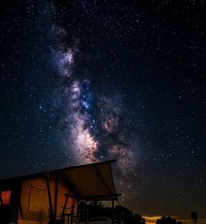 A tent under a starry night sky with the Milky Way visible.