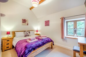 A bedroom with a bed, two bedside tables, a window with curtains, and a desk with a chair. - 5 Bed in Garth (oc-c44957) (Treflys)