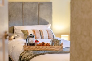 A bed with a tray of breakfast items, a coffee pot, and two mugs. - 2 Bed in Leyburn (oc-n41362) (Leyburn)