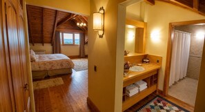 Un dormitorio con cama, armario de madera y ventana con cortinas.