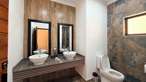 A bathroom with two sinks, a toilet, and a shower area. - Mvubu Falls Lodge (Lobamba)