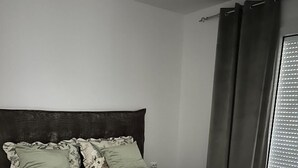 A neatly made bed with a quilted bedspread, two pillows, and a folded blanket. - La Luna 2
Modern Haus im Stadzentrum (Zaječar)