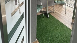 A balcony with a round table, two chairs, a small potted plant, and a decorative wreath. - La Luna 2
Modern Haus im Stadzentrum (Zaječar)