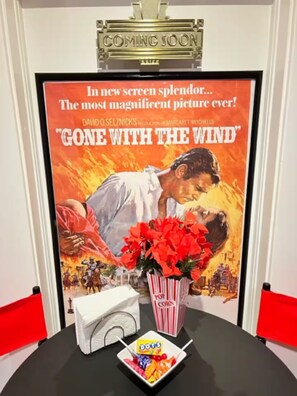 A movie poster for 'Gone with the Wind' with popcorn and candy. - Movie Night 100 Screen Walk to Bars Restaurant (Reno)