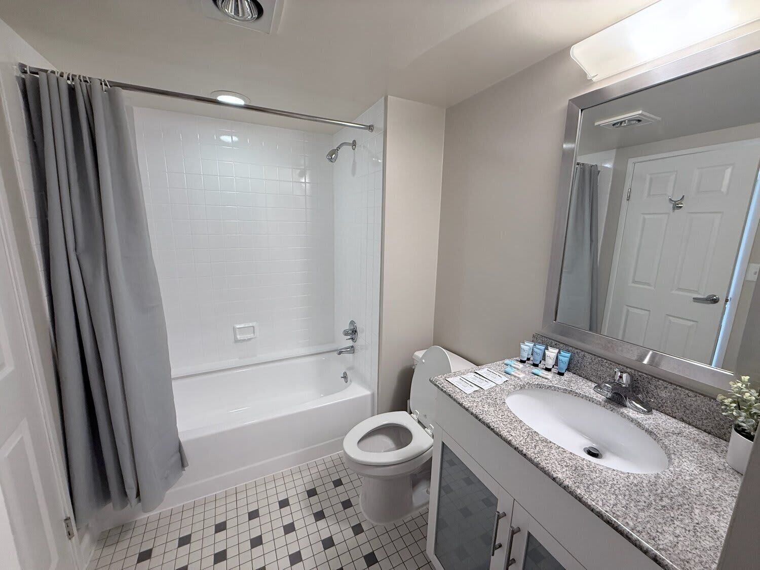 A bathroom with a bathtub, toilet, and sink.